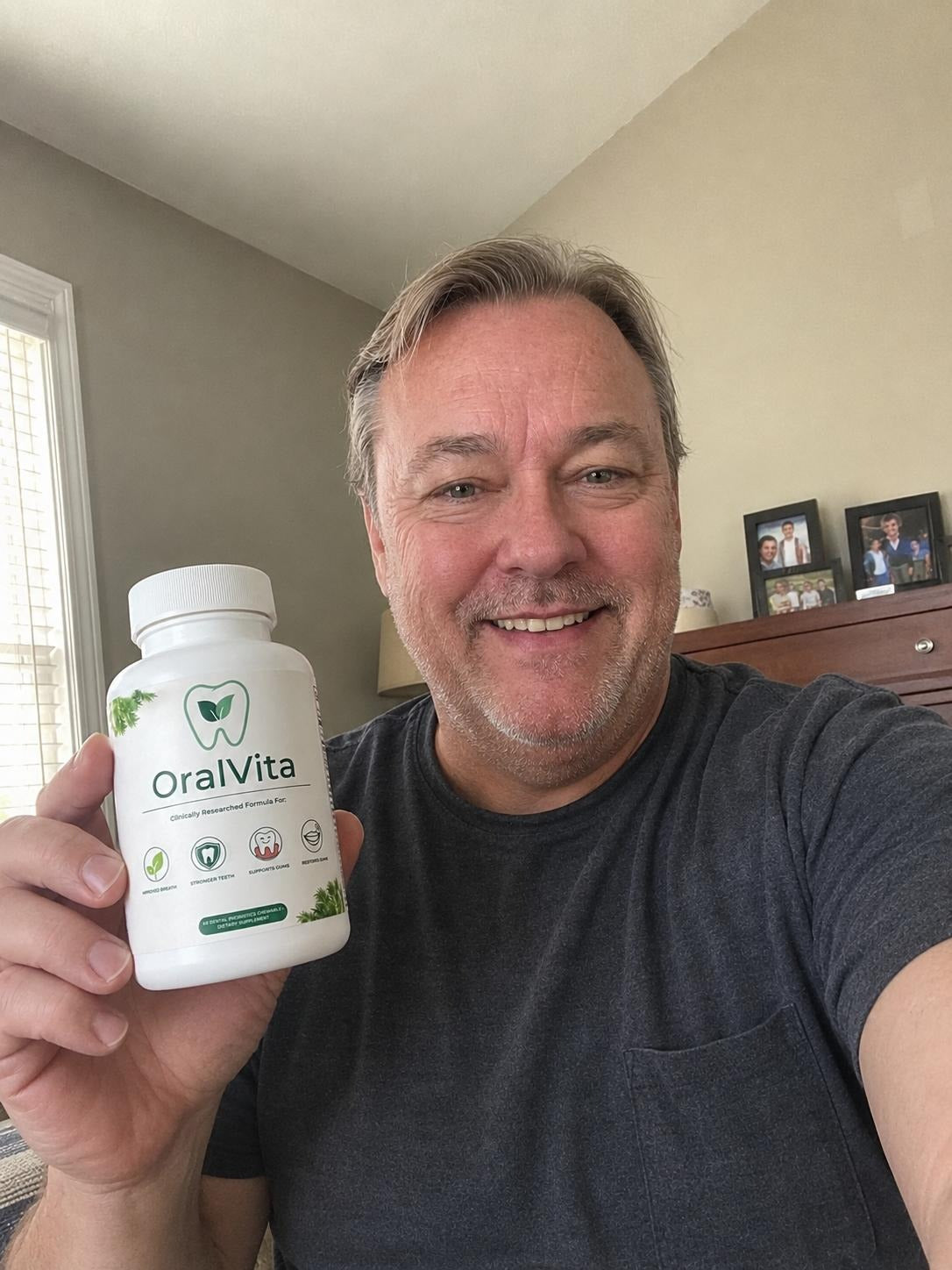 OralVita lifestyle image showing an adult holding the product in a casual home selfie